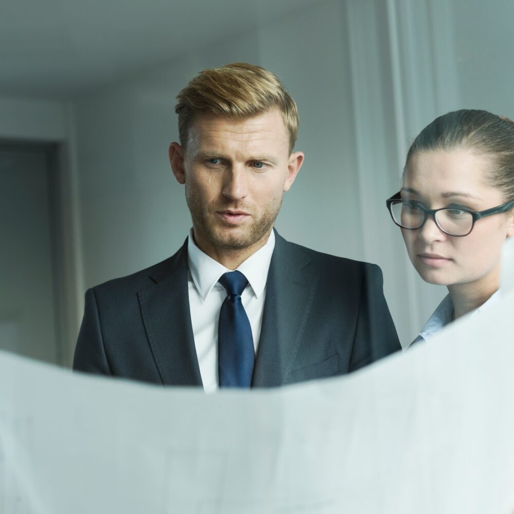 Business people holing construction plan